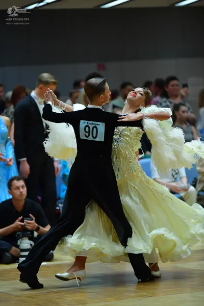 Dancesport competitor #90: Male dancer: black long-sleeved shirt with white ruffled details on the back and