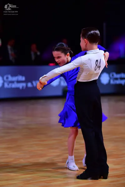 Dancesport competitor: Male dancer: white long-sleeved shirt and black trousers