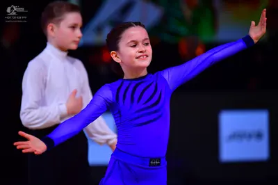 Dancesport competitor: Male dancer: white long-sleeved shirt and black trousers