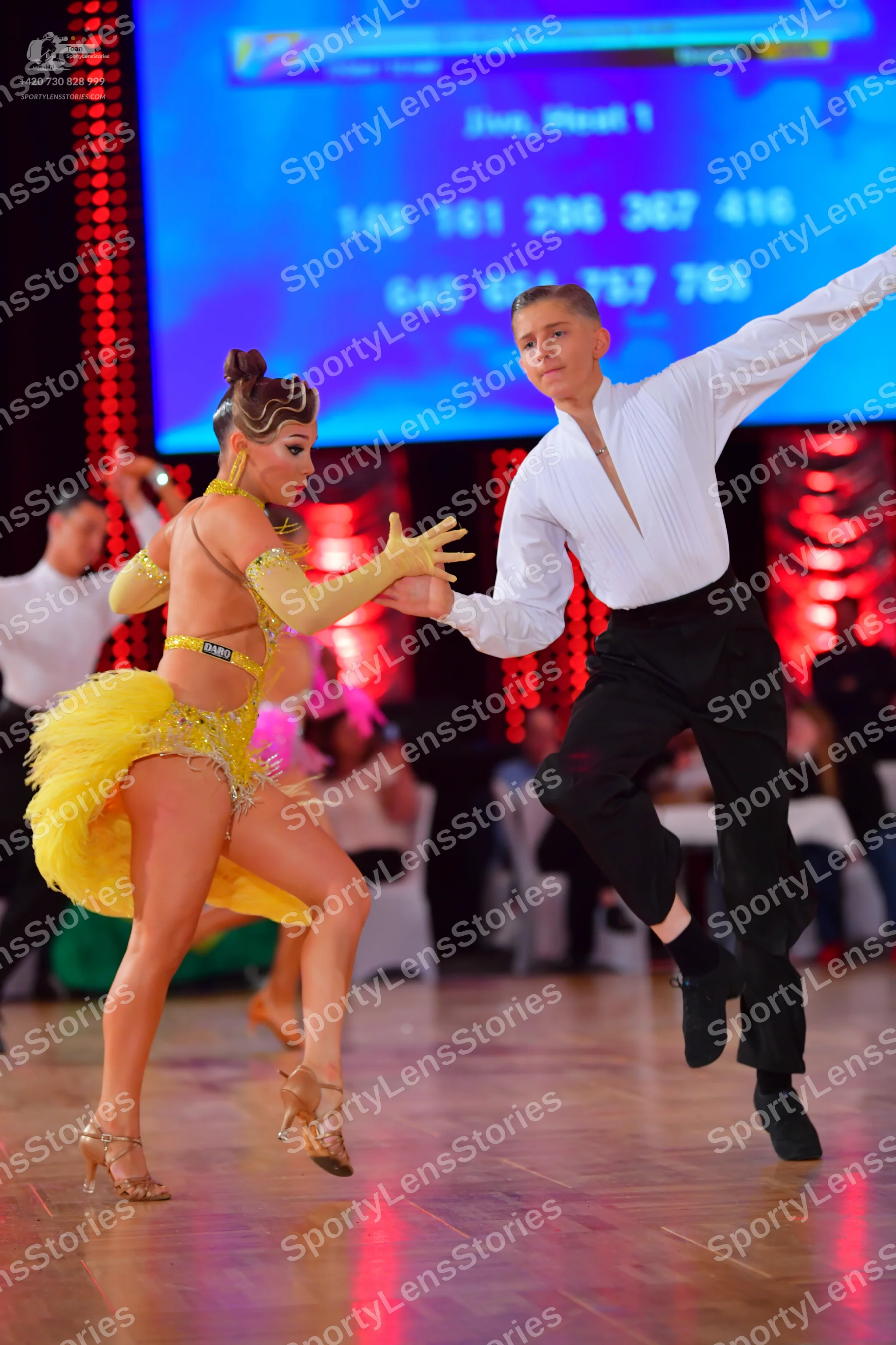Dancesport competitor #328: Female dancer: yellow latin dress with sequins and sheer mesh panels, matching y
