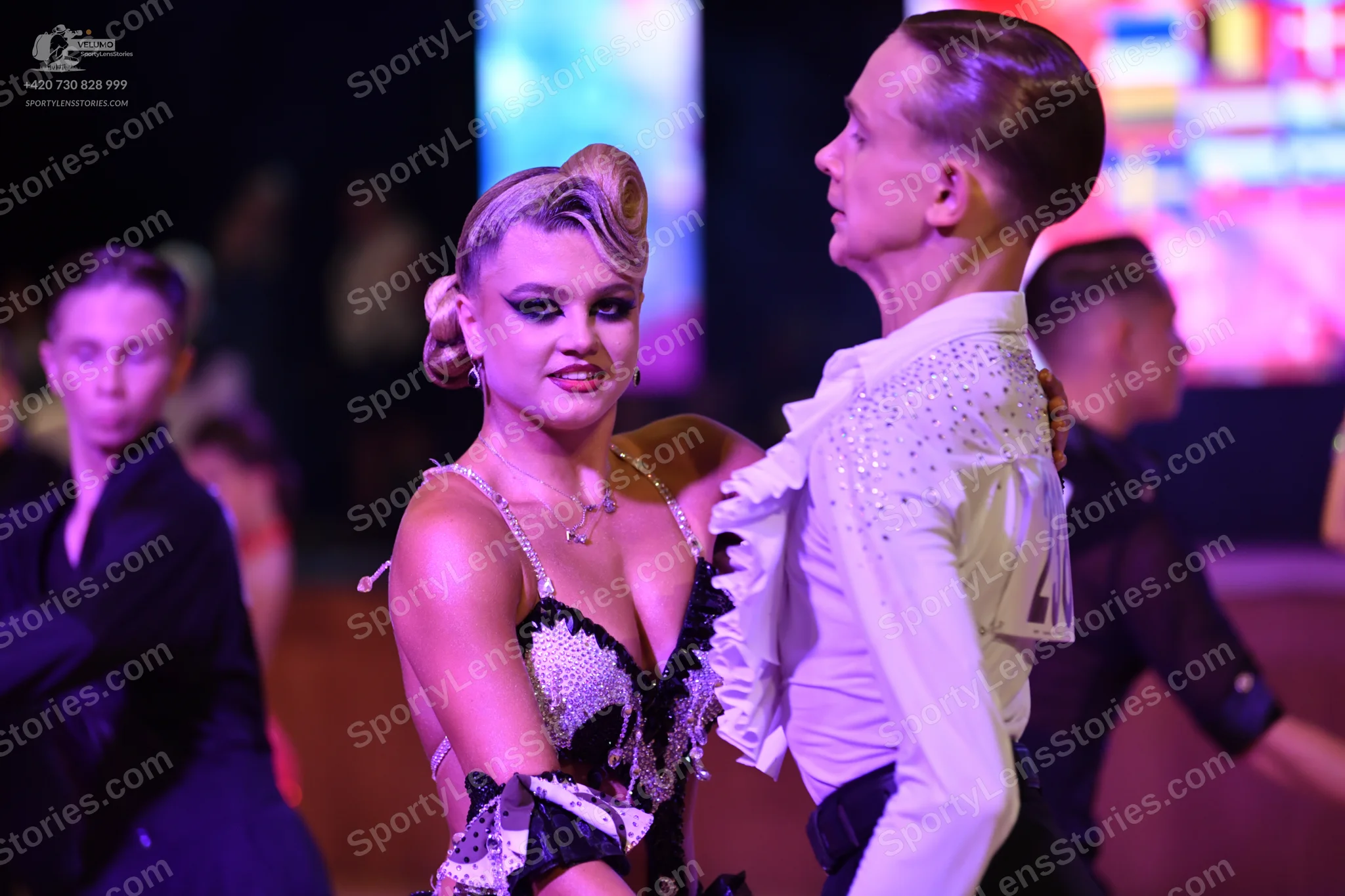 Dancesport competitor: ** Red Latin Dress
*   **Color:** Primarily vibrant red