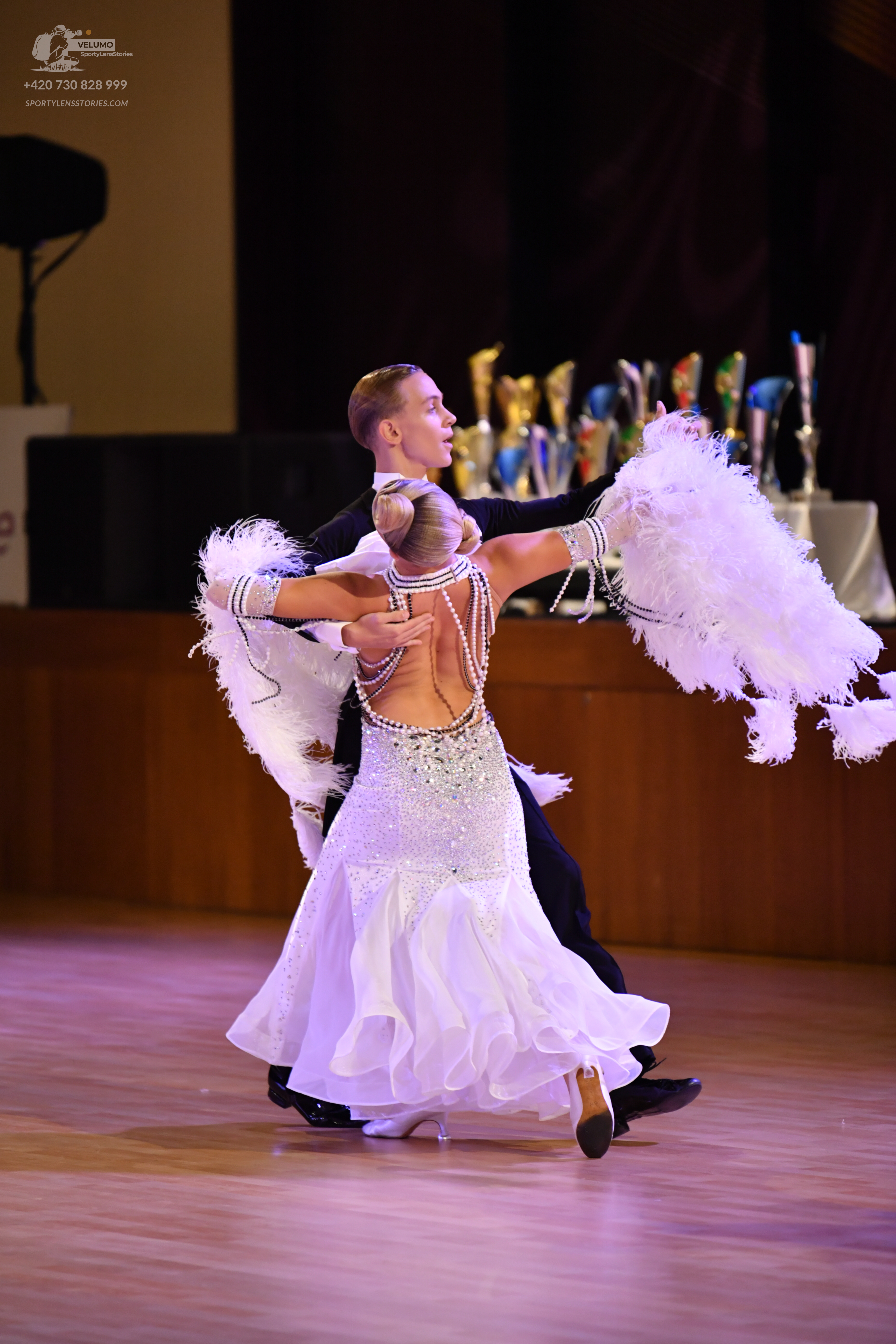Dancesport competitor: Male** - Black, a tail suit with white sequin lapels and a white/silver bodice