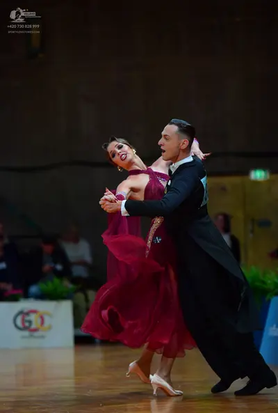 Dancesport competitor: Male dancer: black formal tailcoat, black trousers, and black dance shoes