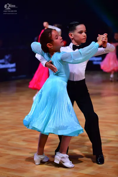 Dancesport competitor: Male dancer: white long-sleeved shirt, black bow tie, and black trousers