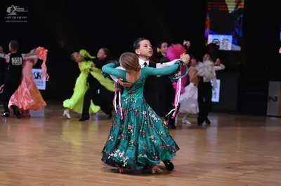 Dancesport competitor: Male dancer (far left): black suit and white shirt