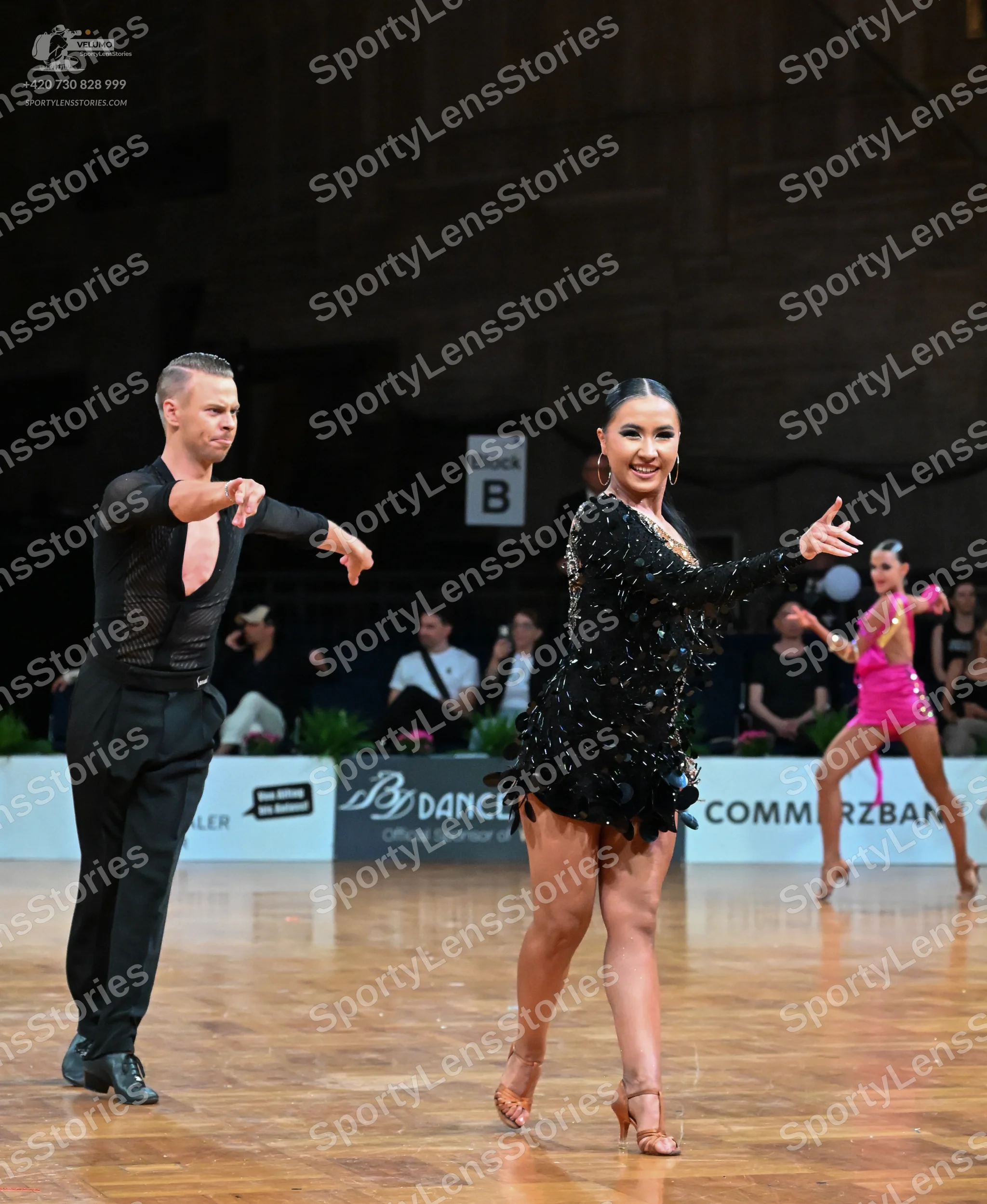 Dancesport competitor: Male dancer: black long-sleeved top with a deep V-neck and black trousers