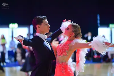 Dancesport competitor: Male dancer: black suit with a white shirt and white tie