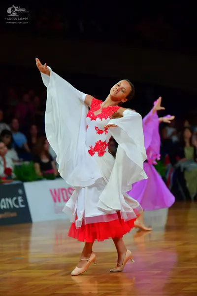 Dancesport competitor: Female dancer 1: white ballroom dress with red floral lace bodice, red ruffled s