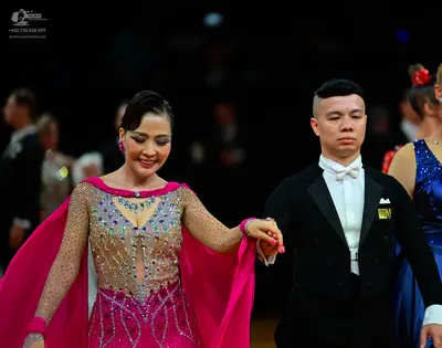 Dancesport competitor #145: Male dancer: black suit with a white shirt, white bowtie, and a yellow pocket sq