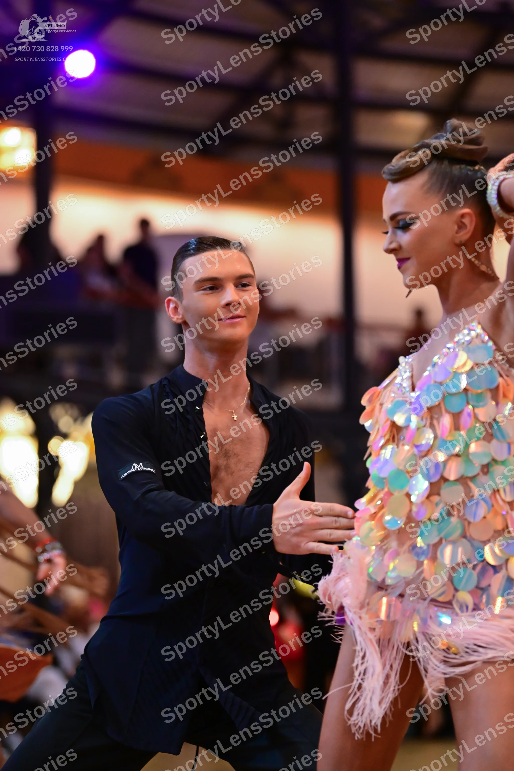 Dancesport competitor: Male dancer: black long-sleeved shirt, partially unbuttoned