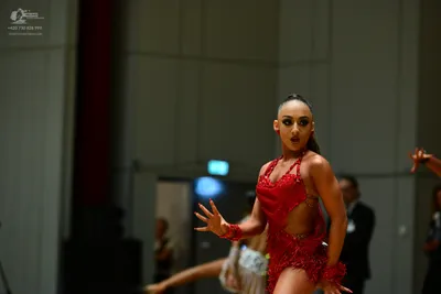 Dancesport competitor: ** Red Latin Dress
*   **Color:** Deep Red
*   **Fabric:** Primarily sequins, wi