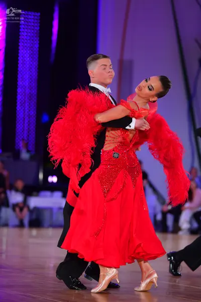 Dancesport competitor: Male dancer: black suit with a white shirt and white bowtie