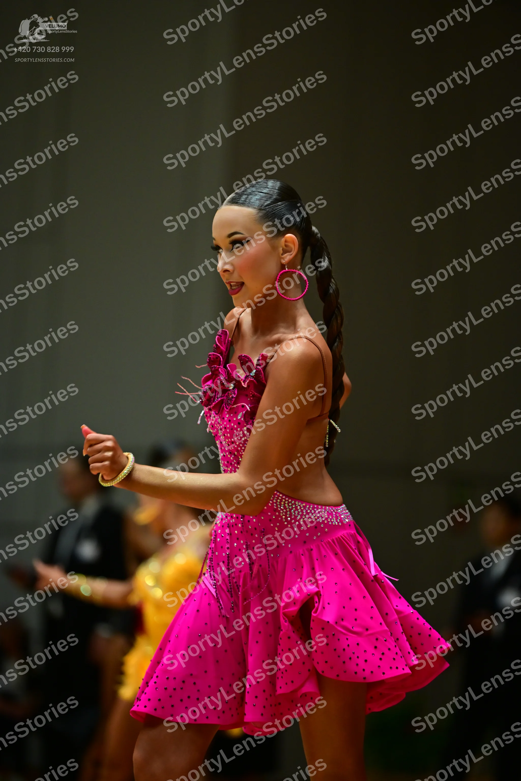 Dancesport competitor: Female dancer: bright pink Latin dress with thin straps and subtle embellishment