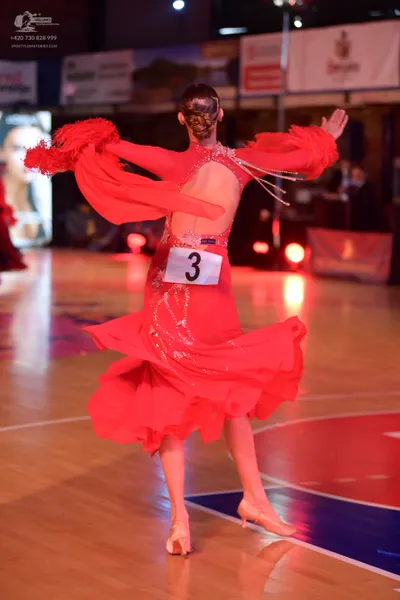Dancesport competitor: Female dancer: red latin dress with fringe and embellishments
