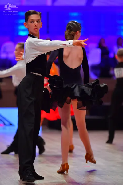 Dancesport competitor: Male dancer: black and white long-sleeved shirt with black trousers