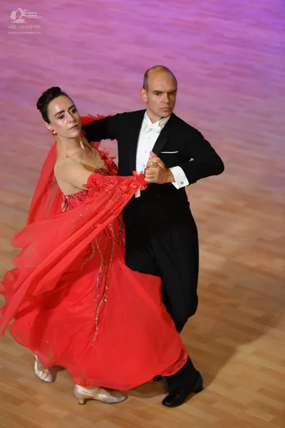 Dancesport competitor: Male:** Black tail suit with a prominent sequin-covered lapel