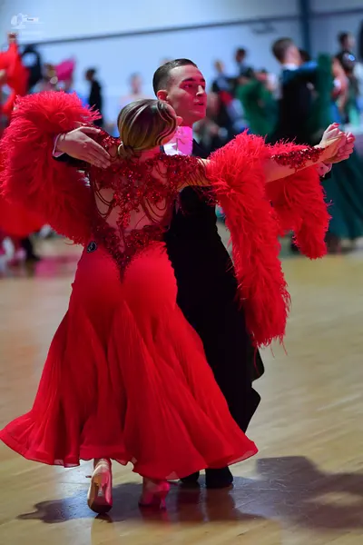 Dancesport competitor: Female dancer: red Latin dance dress with a sequined/beaded bodice and large red