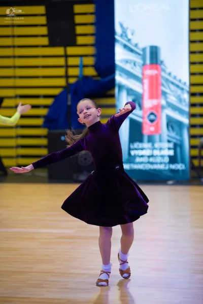 Dancesport competitor: ** Black, fitted, short skirt and top