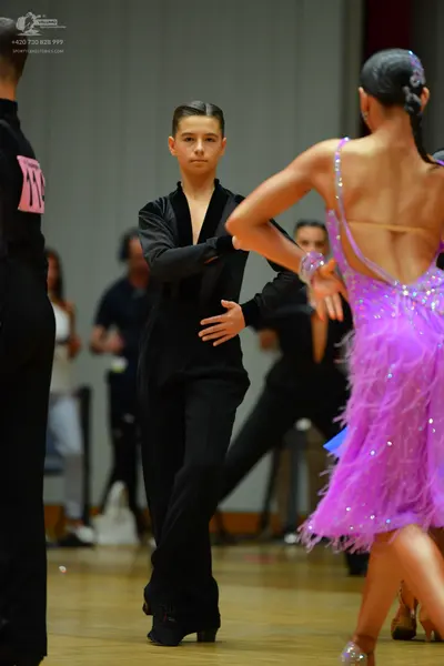 Dancesport competitor: Male dancer: black long-sleeved top and black trousers
