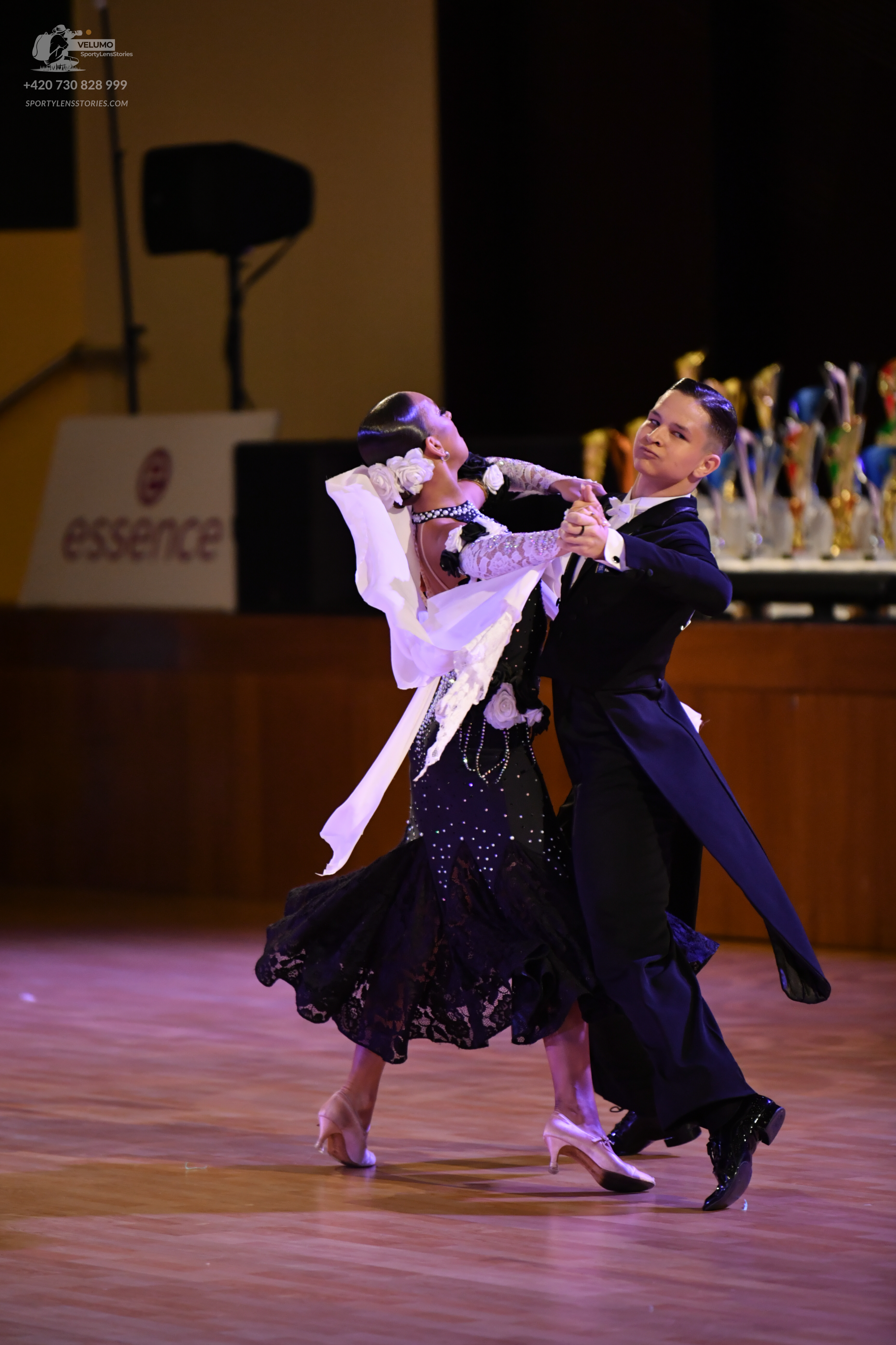Dancesport competitor: ** Black tail suit
*   **Fabric:** Primarily satin, with sequin lapels adding sh