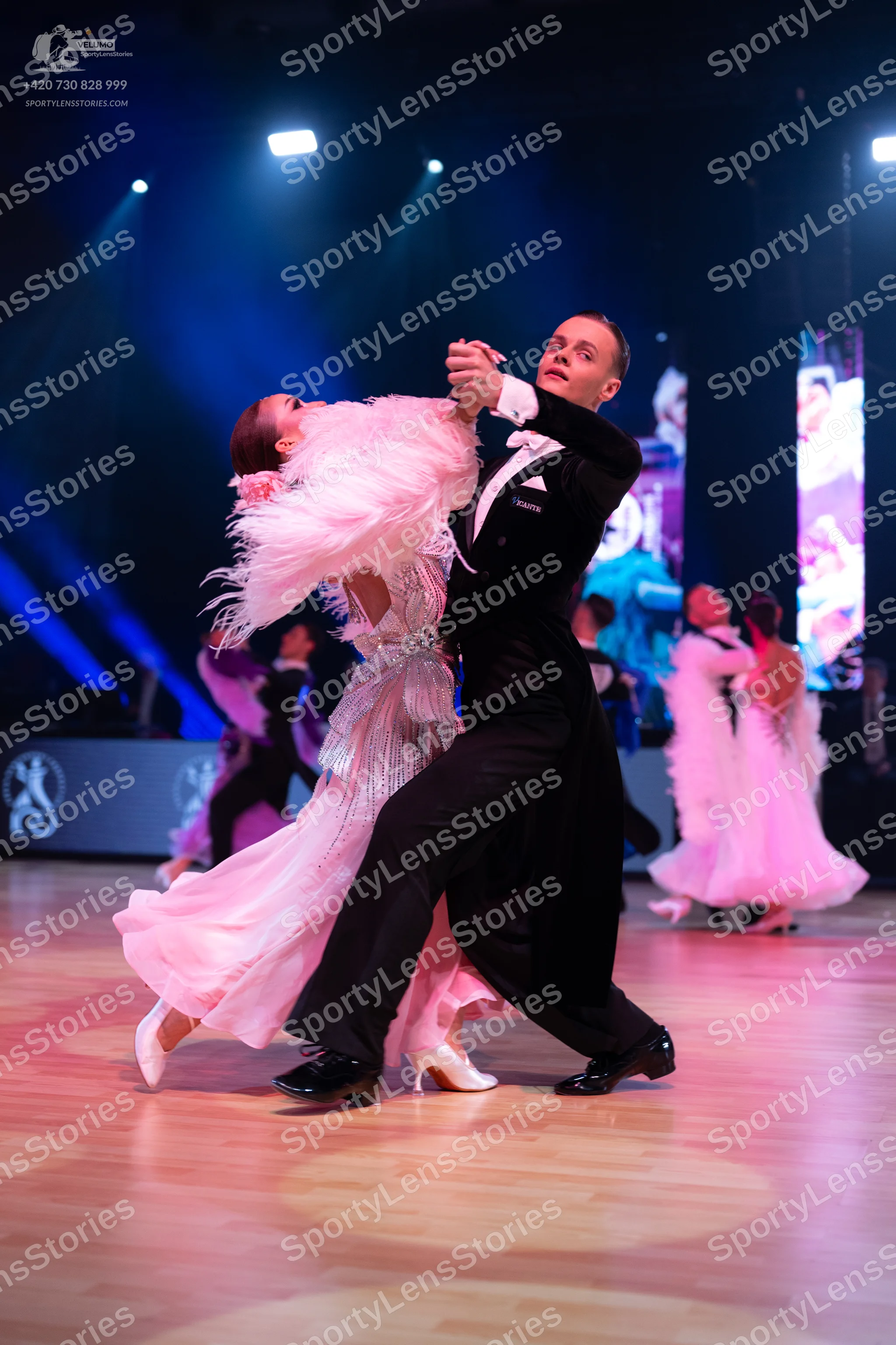 Dancesport competitor: Male dancer: black suit with a white shirt and white pocket square