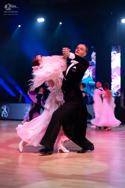 Dancesport competitor: Male dancer: black suit with a white shirt and white pocket square
