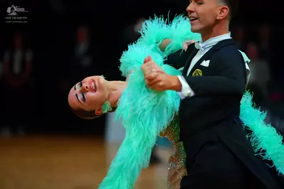 Dancesport competitor: Male dancer: black suit with a white pocket square and white shirt