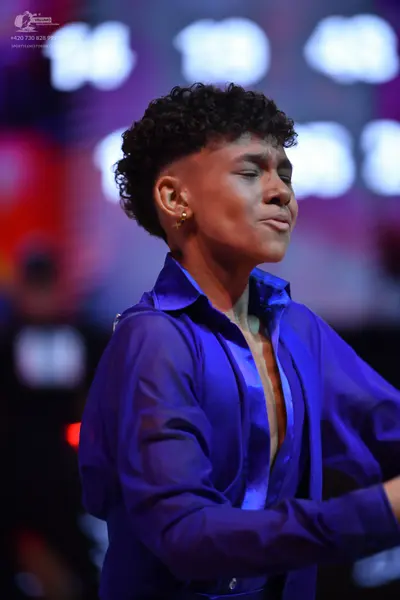 Dancesport competitor: Male dancer: blue long-sleeved satin-like shirt with a collar, partially unbutto