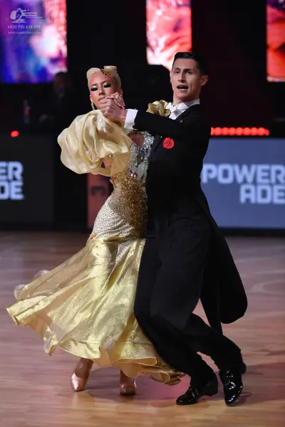 Dancesport competitor: Male dancer: black suit with a white shirt and a white bow tie