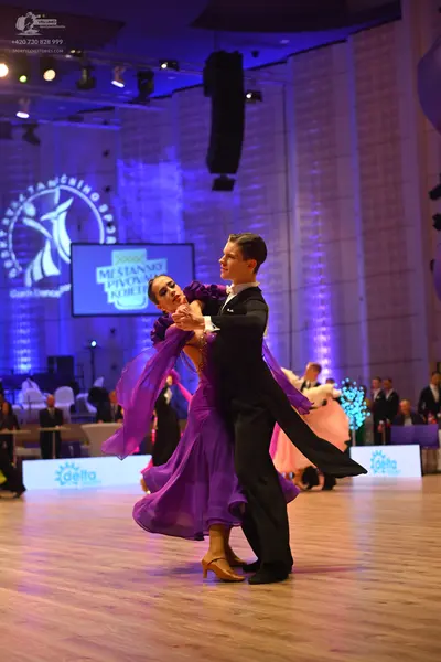 Dancesport competitor: Male dancer: black suit with a white shirt and black bow tie