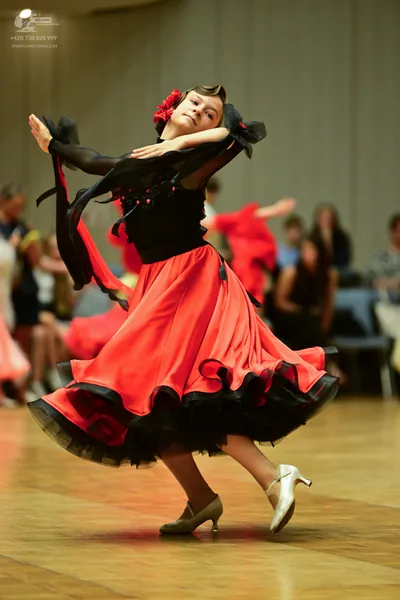 Dancesport competitor: ** Red Latin Dress
*   **Fabric:** Satin (appears to be a shiny, smooth satin)
*