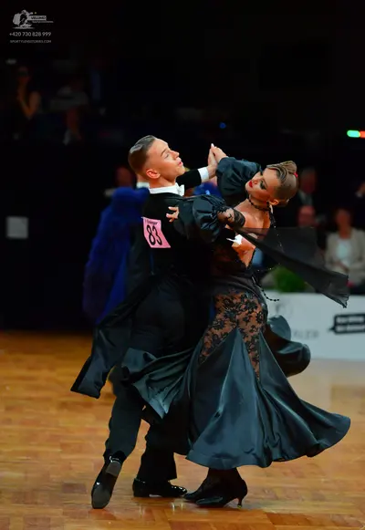 Dancesport competitor: Male dancer: black ballroom tailcoat with a white shirt collar
