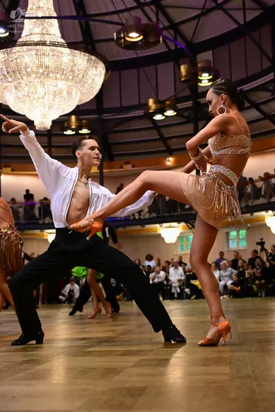 Dancesport competitor: Male dancer: white long-sleeved open jacket and black trousers