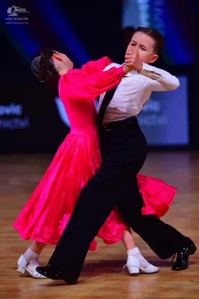 Dancesport competitor: Male dancer: white long-sleeved shirt, black trousers, black tie, and black danc