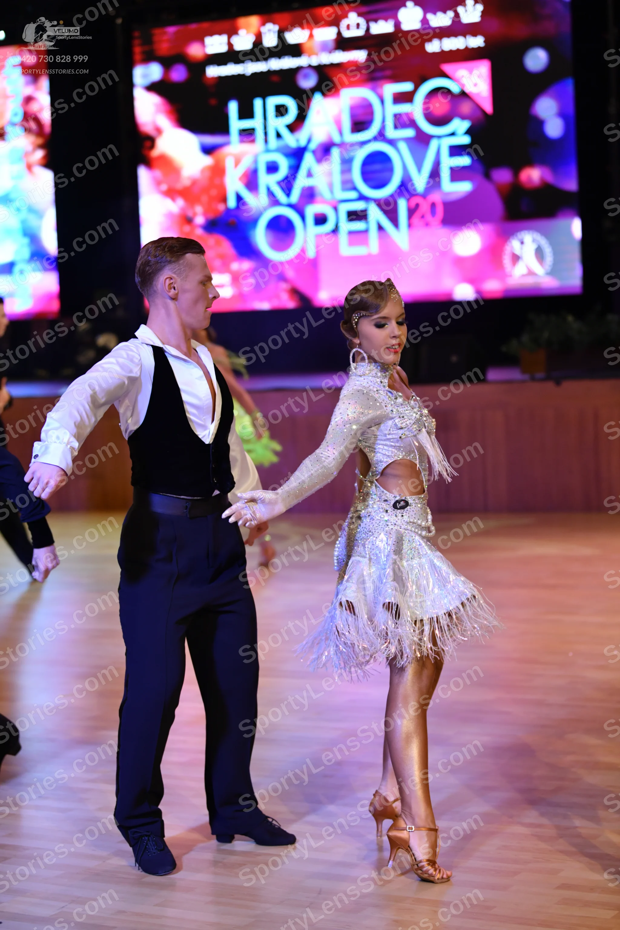 Dancesport competitor: Male dancer: white long-sleeved shirt, black waistcoat, and black trousers