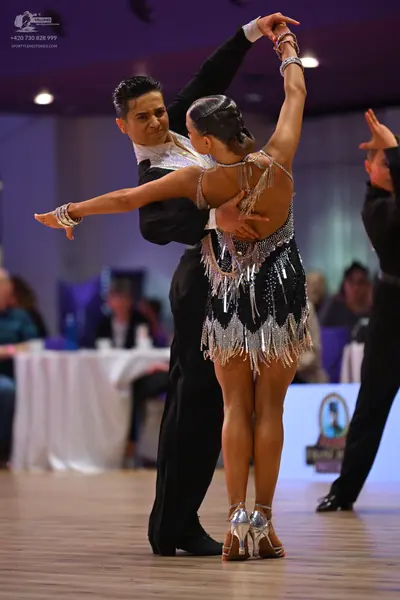 Dancesport competitor: Male dancer: black suit with a white detailed shirt