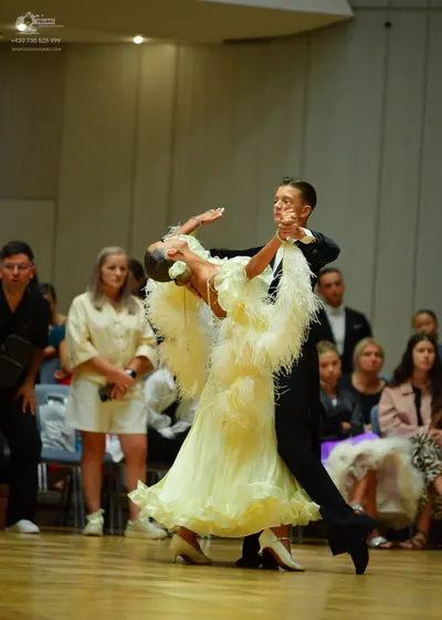 Dancesport competitor: Male dancer: black suit with a white shirt
