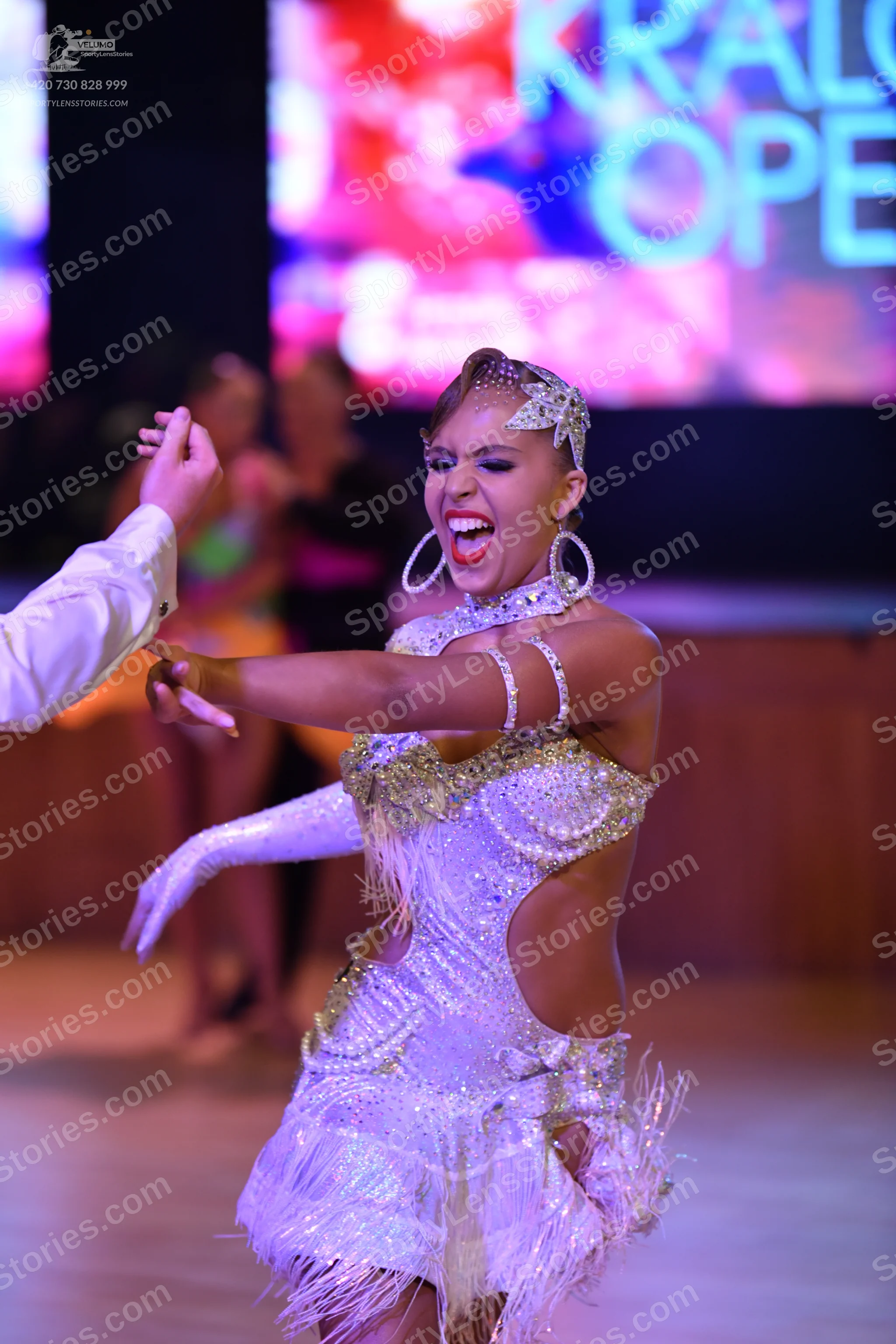 Dancesport competitor: Okay, here's a breakdown of the dancers' costumes in the photo, formatted as you