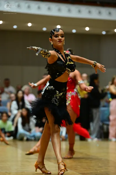 Dancesport competitor: ** Female: Black, body-hugging Latin dress
