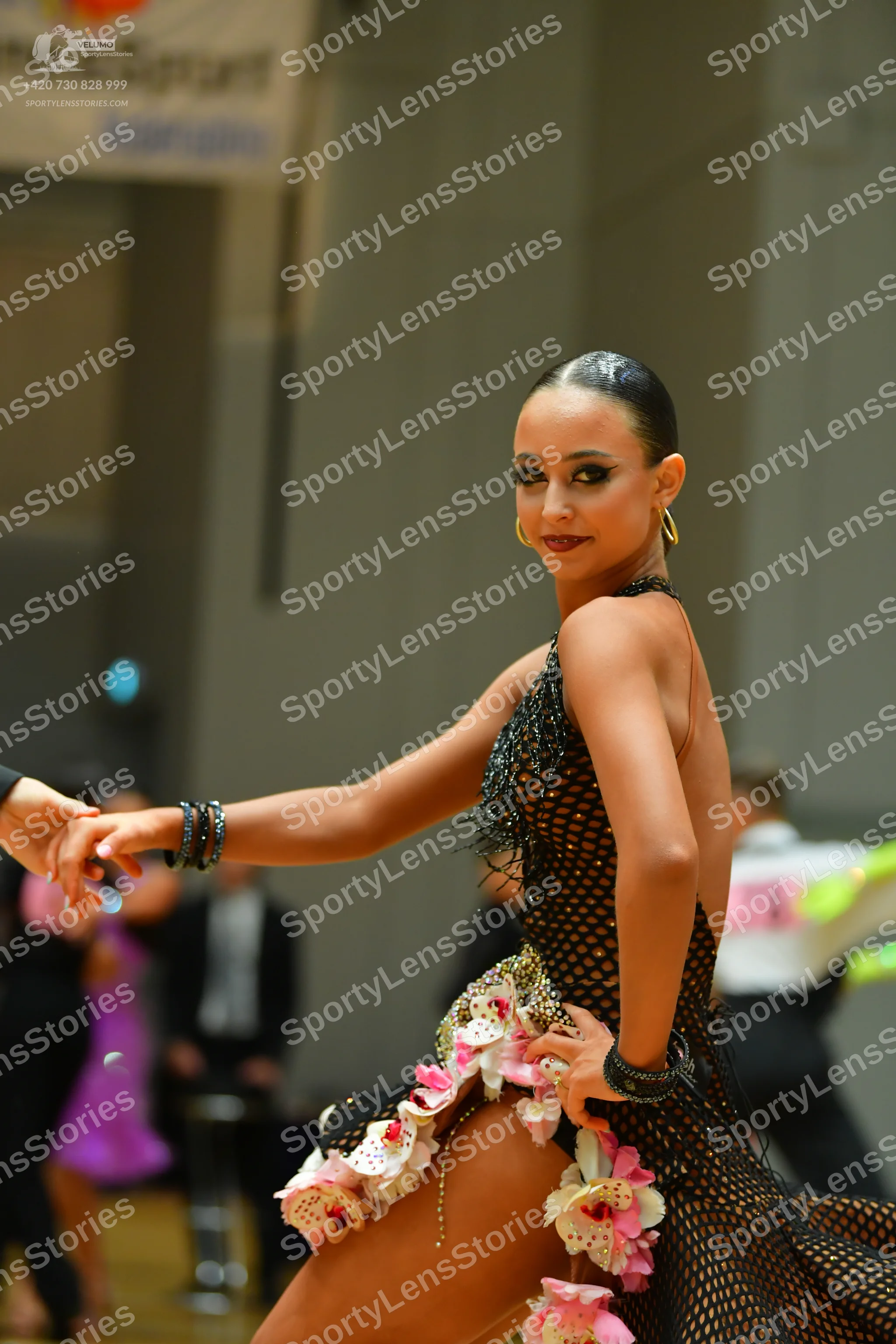 Dancesport competitor: Main female dancer: black mesh latin dress with pink and white floral appliques,