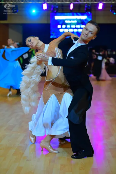 Dancesport competitor: Male dancer: black suit, white shirt, white bowtie, and black trousers
