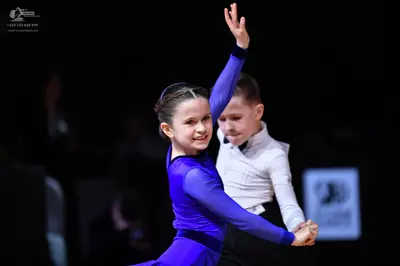 Dancesport competitor: Female dancer: blue long-sleeved dance dress