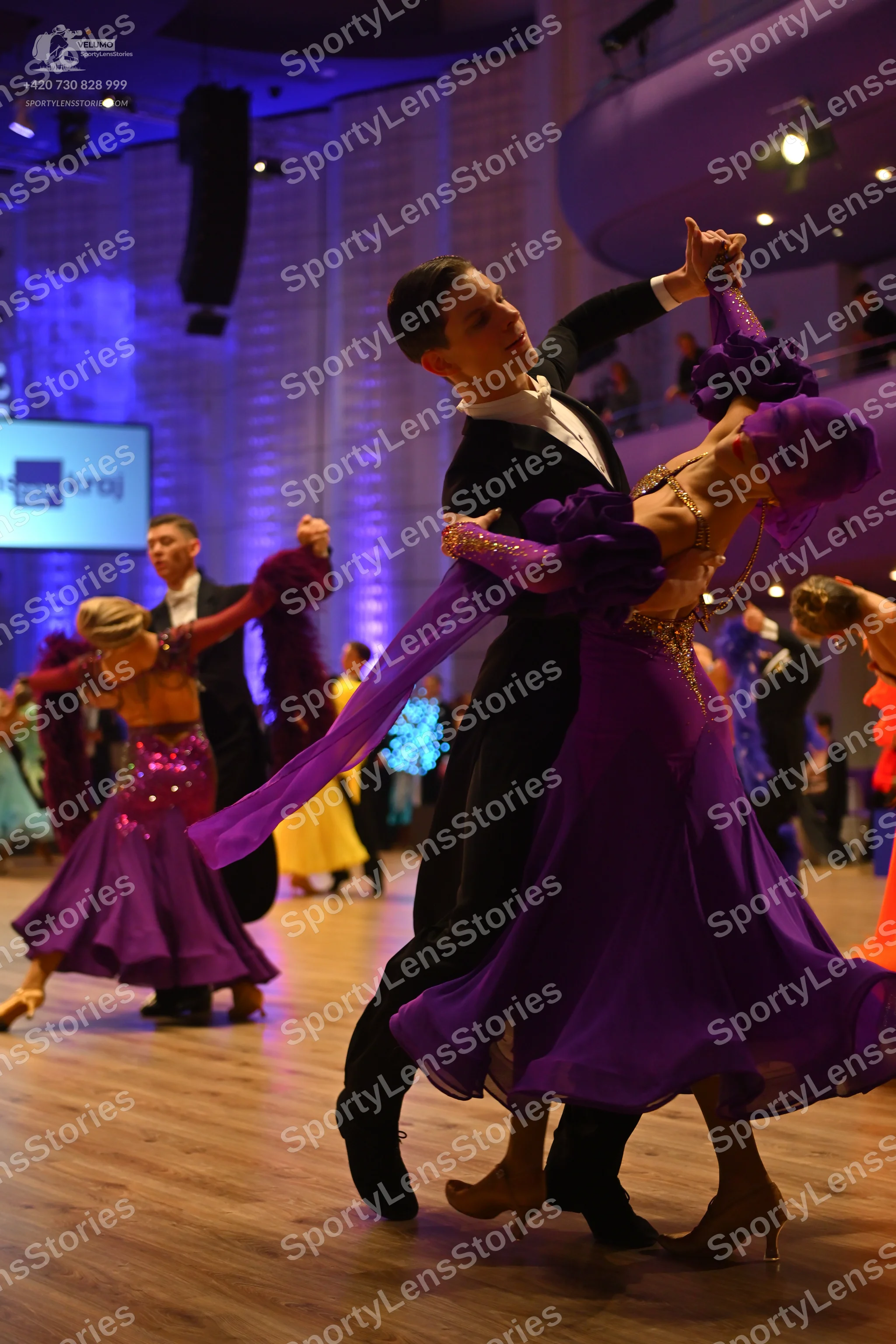 Dancesport competitor: Main male dancer: black suit, white shirt, and white bow tie