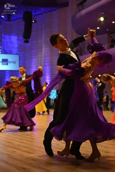 Dancesport competitor: Main male dancer: black suit, white shirt, and white bow tie