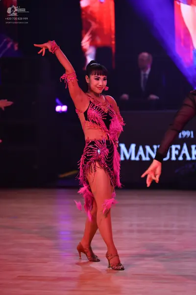 Dancesport competitor: Female dancer: pink Latin dress with fringe and sequins