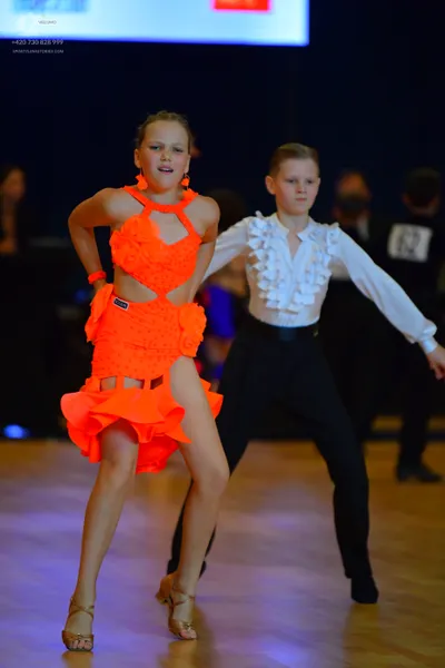 Dancesport competitor #62: Female dancer: bright orange Latin dance dress with a halter neck, side cutouts,