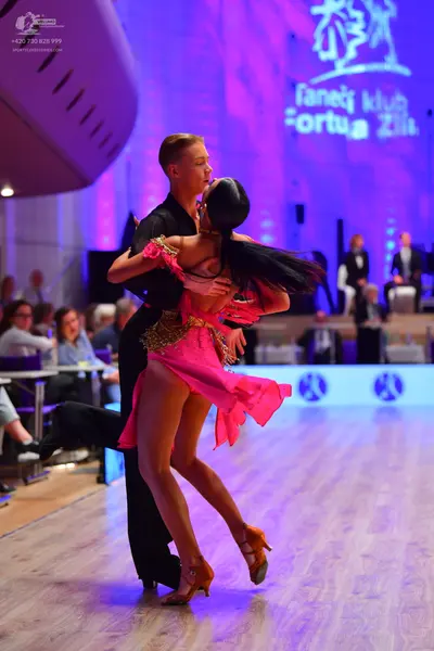 Dancesport competitor: Male dancer: black long-sleeved shirt and black trousers