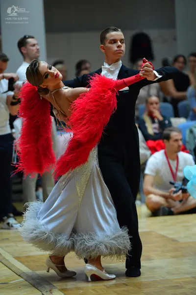 Dancesport competitor: Male dancer: black ballroom suit with a white shirt and white cravat