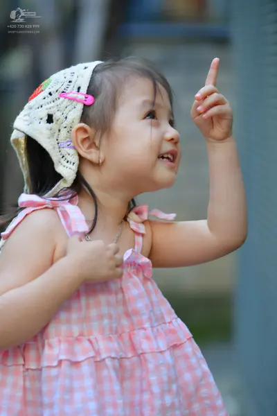 Dancesport competitor: Female dancer: pink and white gingham sleeveless dress with ruffles, a white lac