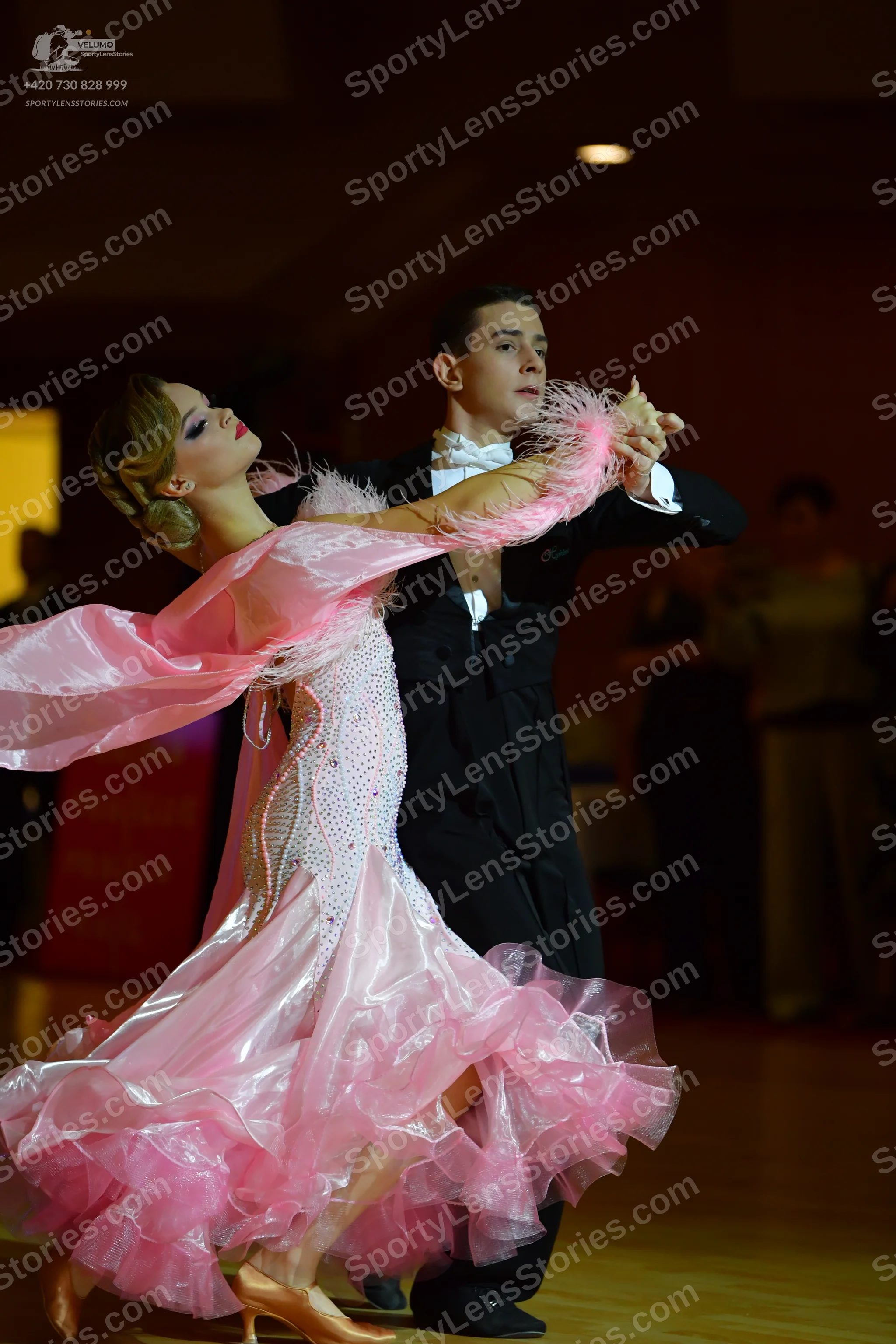 Dancesport competitor: Male dancer: black formal suit with a white shirt and white bowtie